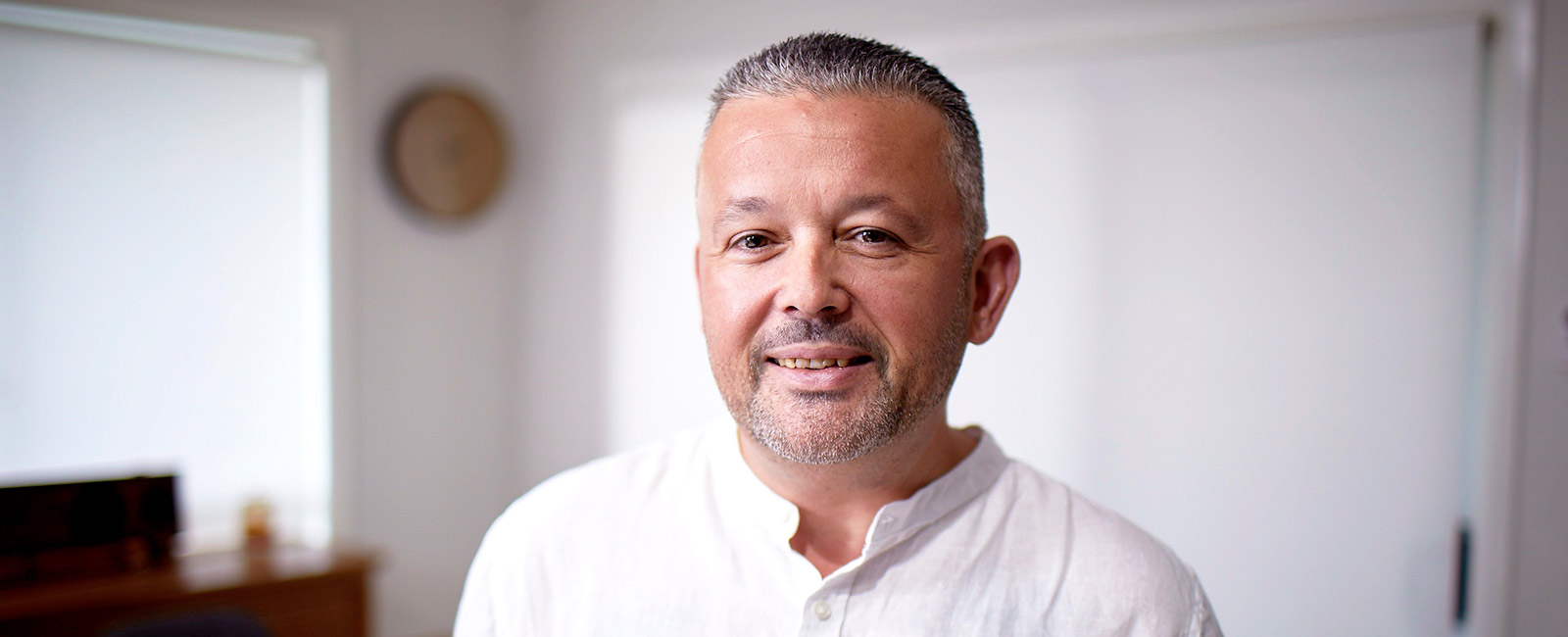 A man smiling at the camera who had undertaken weight loss surgery